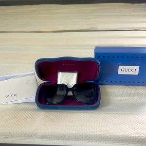 New pair of Gucci sunglasses with tags, black with rhinestones on side as shown